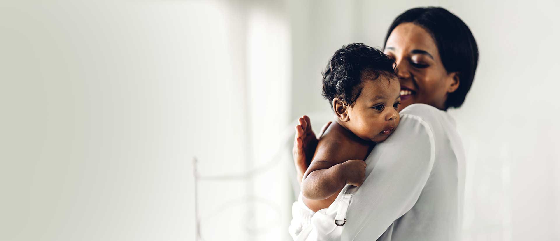 Chris standing up holding his daughter Elva